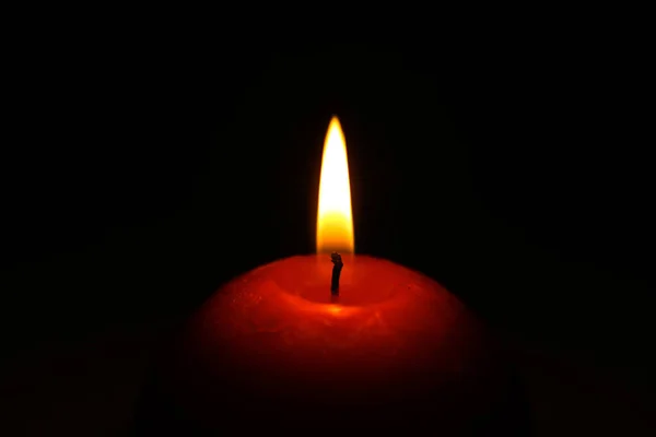 Funeral flaming candle isolated on black background