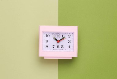Square table clock on a green background