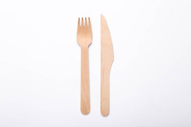 Wooden knife and fork on a white background. Eco products