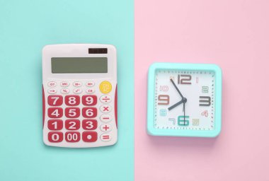 Calculator with clock on pink pastel background. Business concept. Top view