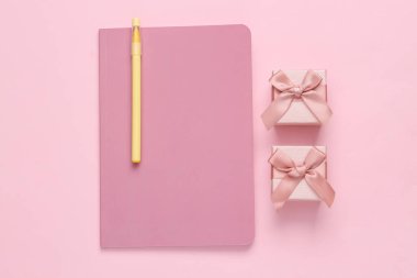 Girly diary and gift boxes on a pink background. Top view, flat lay