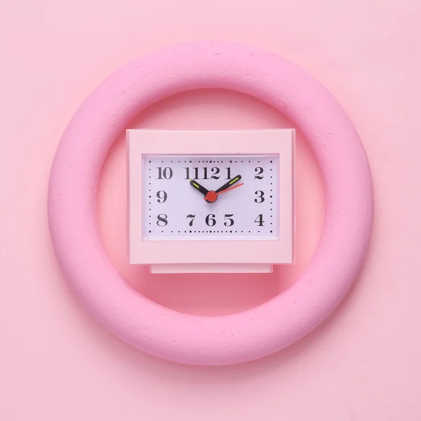 Pink square table clock in round on pink pastel background