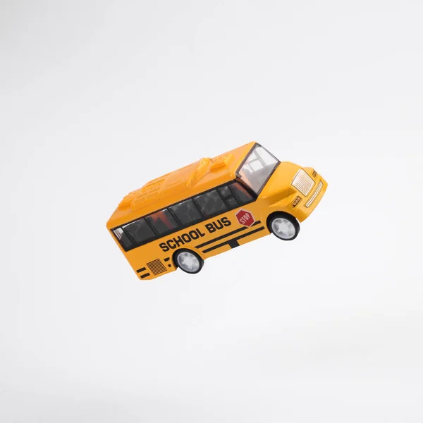 Miniature Yellow School Bus Hovering Air White Background — Stock Photo, Image