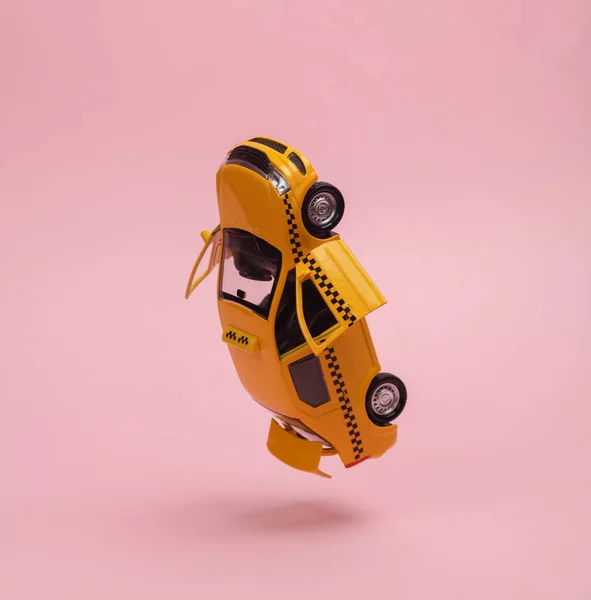 Levitating, hovering in antigravity model of taxi car with open doors and trunk on pink background