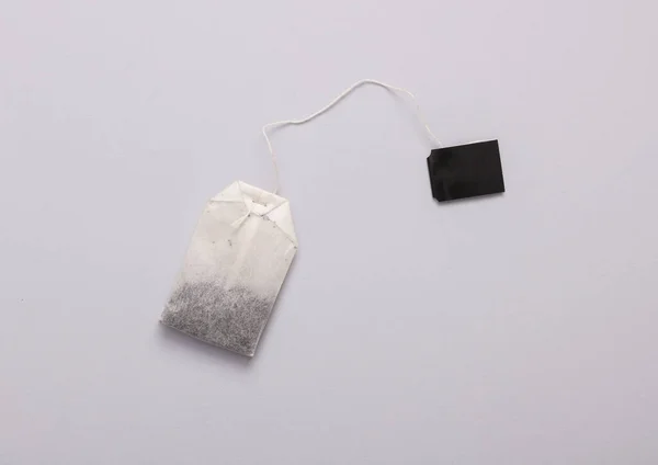 stock image Tea bag with blank black label on gray background. Top view