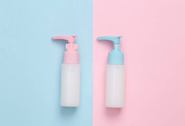 Bir şişe krema ya da üzerinde mavi-pembe pastel arka planda şeker kutusu olan sıvı sabun. Yaratıcı güzellik hala hayat