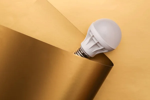 Led light bulb on a luxurious golden background