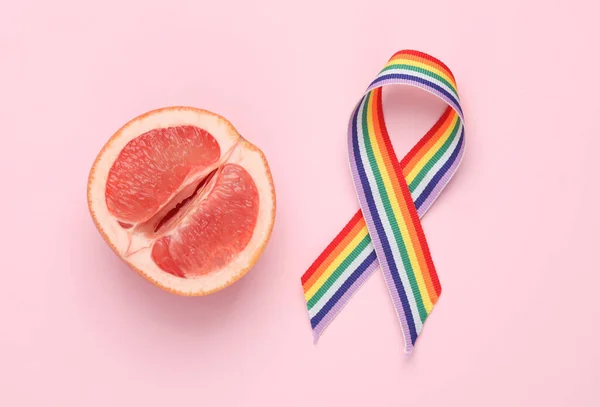 Half Grapefruit Symbolizing Vagina Lgbt Rainbow Ribbon Pink Background — стоковое фото