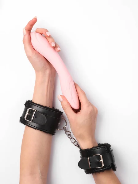 Female Hands Leather Handcuffs Sex Shop Holds Vibrator Dildo White — стоковое фото