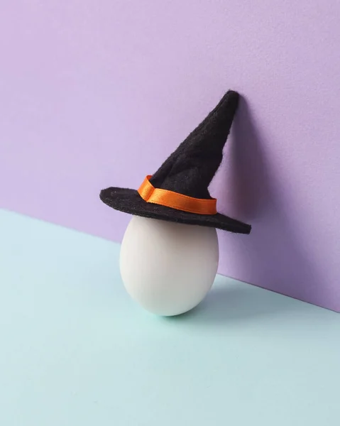 創造的なハロウィーンのレイアウト 魔女の帽子の卵がパステルの背景に 概念的なポップ 最小限の静物 — ストック写真