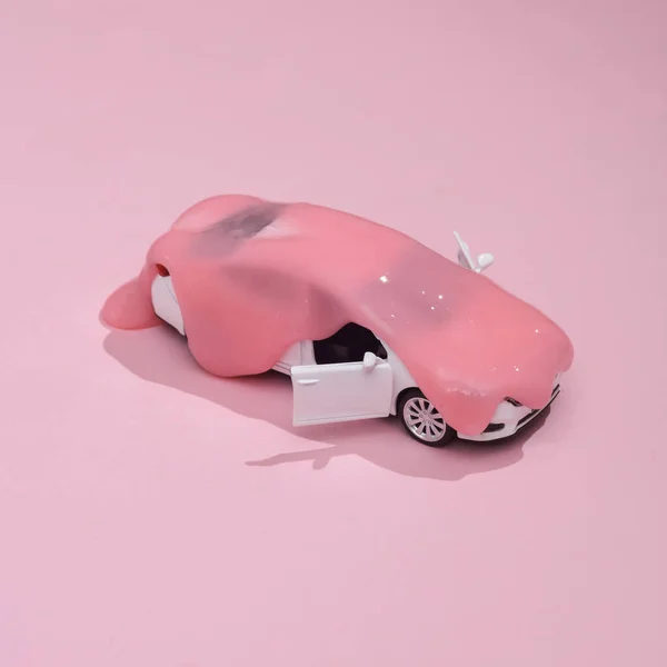 stock image Creative layout, toy car with slime on pink background with shadow. Visual trend. Fresh idea. Concept pop