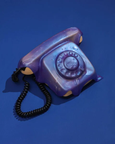 Creative retro layout, rotary phone with slime on dark blue background with shadow. Visual trend. Fresh idea. Concept pop