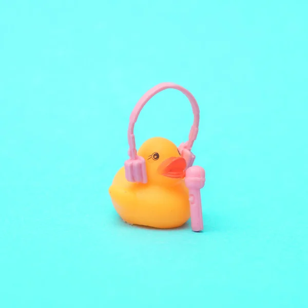 stock image Rubber duck in headphones with a microphone on a blue background