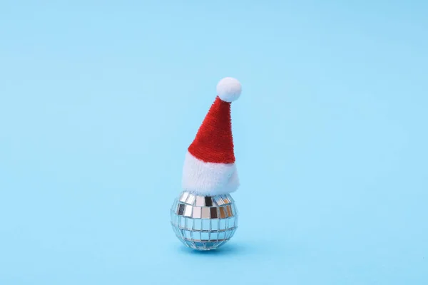 stock image Disco ball in santa hat, blue background