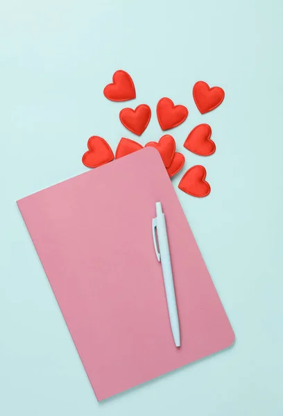 stock image Pink Notebook with hearts on a blue background. Romantic, love, valentine's day concept