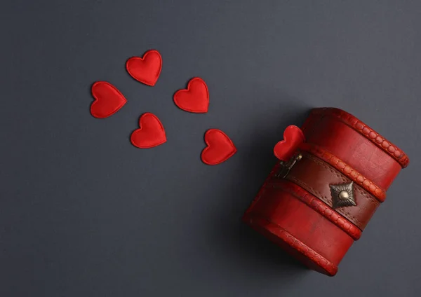 Pirate chest with hearts on gray background