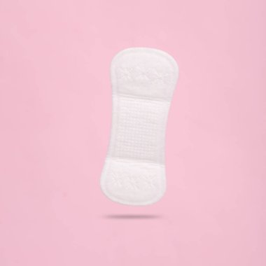 Kadınların hijyenik pedi pembe arka planda, gölgeli bir şekilde yükseliyor. Kadın hijyeni.