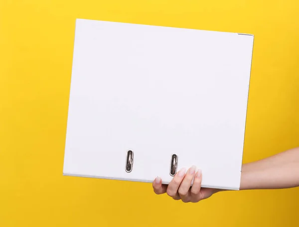 Woman Hand Holds White Binder Rings Yellow Background — Stock Photo, Image