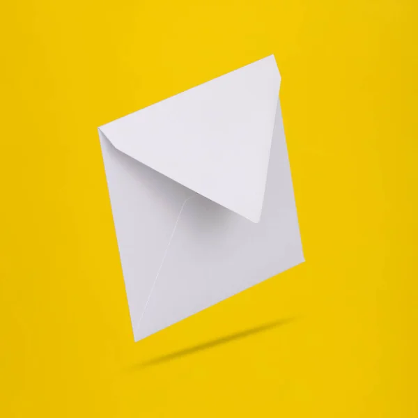 Envelope Branco Vazio Levitando Fundo Amarelo Com Sombra — Fotografia de Stock