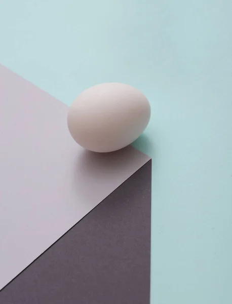 stock image Egg on a paper cube. Optical illusion. Food concept. Geometric composition. Minimalistic creative layout