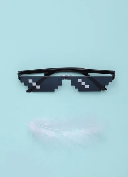 带羽毛蓝色背景的Pixel太阳镜 创意布局 — 图库照片