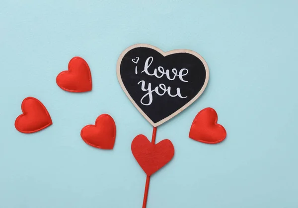 Stock image Stick with the word I love you and hearts on a blue background. Valentine's Day