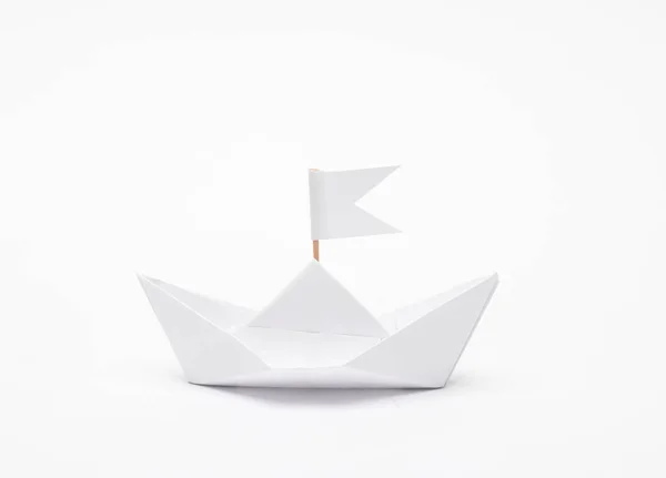 stock image White Paper boat with a flag on white background. Leadership concept