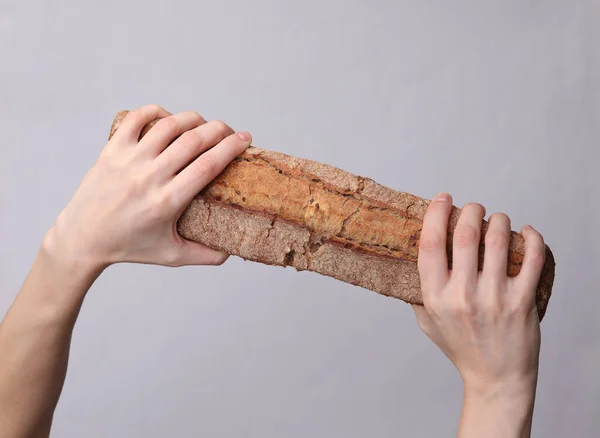 Female Hands Holding Rye Baguette Gray Background — Stock Photo, Image