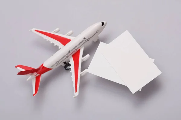 stock image White Blank business cards for branding and toy air plane on gray background. Creative Mockup for presentations and corporate identity. Travel Company.