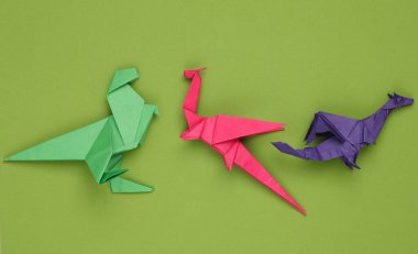 Yeşil arkaplanda Origami ejderhaları