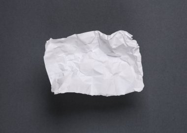 Gri arkaplan üzerine beyaz buruşmuş kağıt parçası