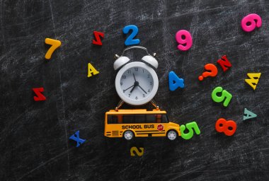 Tebeşir tahtasında okul malzemeleri var. Eğitim konsepti. Düz yatıyordu. Üst görünüm