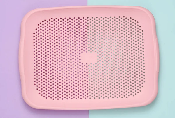 Plastic tray on a pastel background. Kitchen accessories