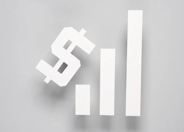 Papperskolonner Ett Diagram Som Tenderar Uppåt Och Dollarsymbol Grå Bakgrund — Stockfoto
