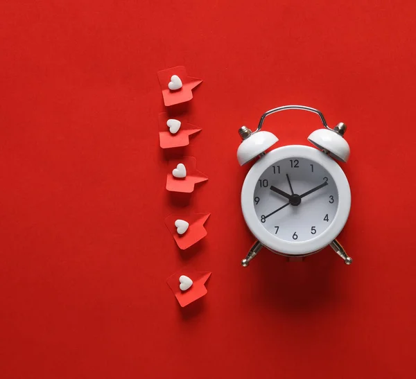 Alarm clock with Social media likes on red background. Creative minimal layout