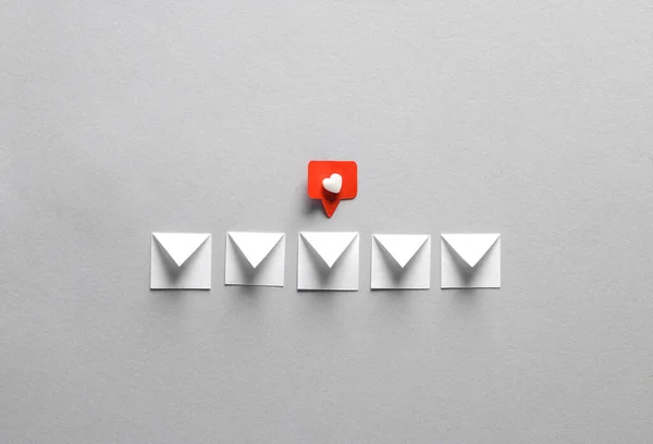 stock image Paper cut notification message mail envelope with Social media like on gray background. Creative minimalism layout