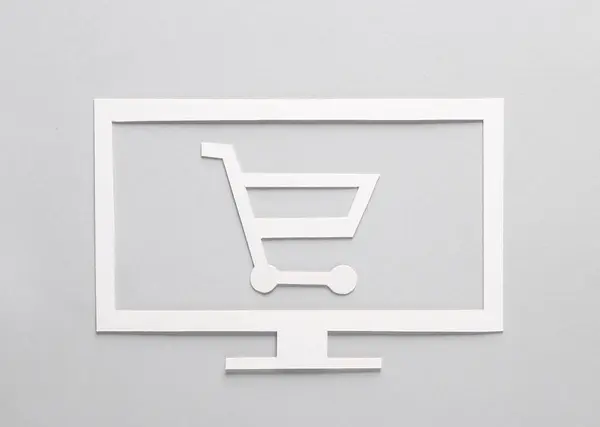 Paper-cut tv and shopping trolley on gray background