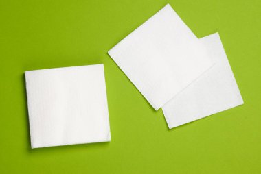 Yeşil arka planda beyaz kağıt peçeteler. Üst görünüm