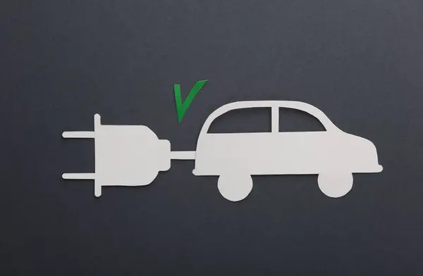 Electric car. Paper cut car with electric plug and acceptance checkmark on dark background