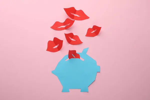 Paper-cut piggy bank with lips on a pink background. Valentine\'s day, economics, business and finance