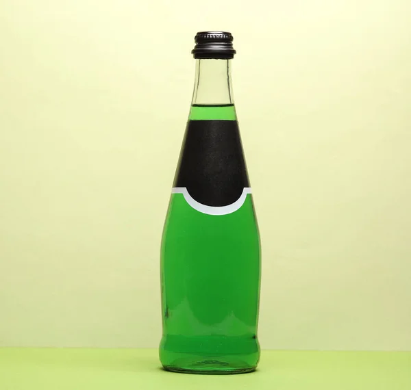 Bottle of green Irish beer on a green background