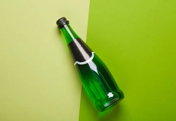 Bottle of green Irish beer on a green background. Top view