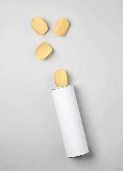 White tube of potato chips on a gray background. Mock up for template design. Space for text