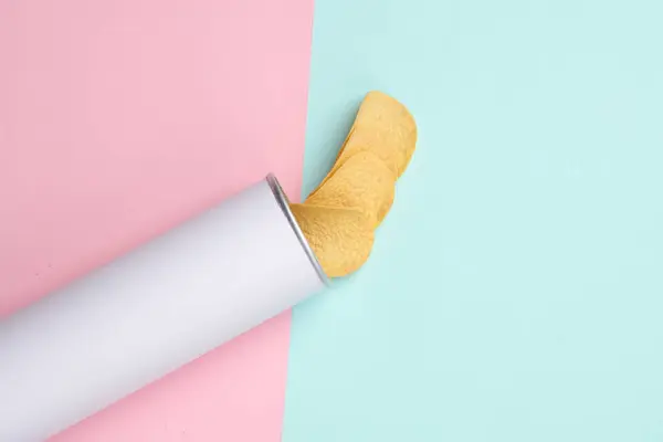 White tube of potato chips on pink blue background. Mock up for template design. Space for text.  Top view