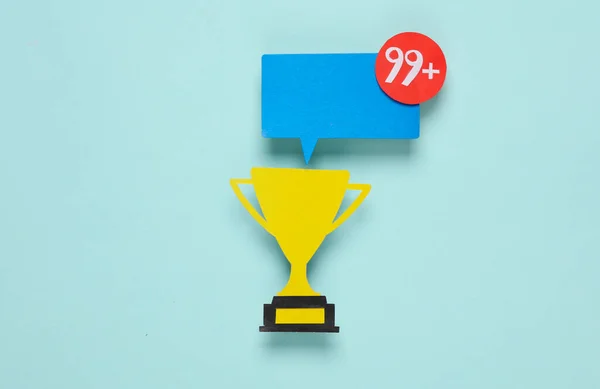 Paper cut winner cup and Notification speech bubble with 99 number on blue background. Social media chat, sport, message, sms, subscribe notice alert and reminder.