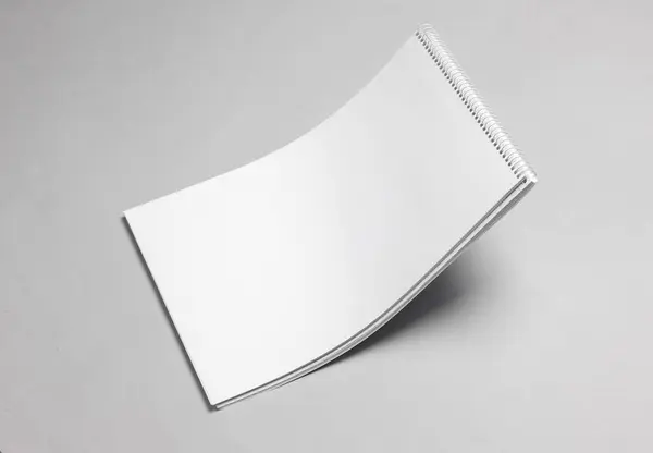 Levitating white blank sketchbook on gray background