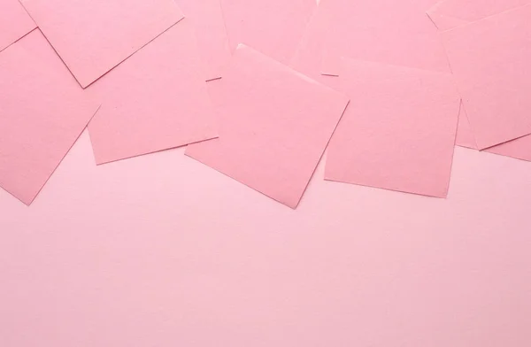 Pink square memo sheet of papers on pink background. Copy space