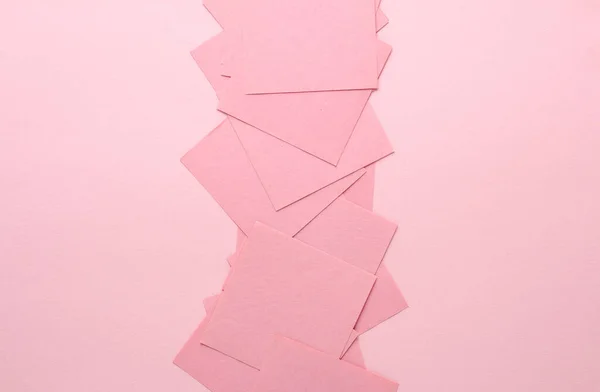 Pink square memo sheet of papers on pink background.