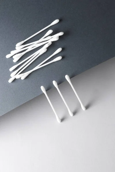 Hygiene ear cotton swabs for cleaning ears on a dark gray background. Creative layout