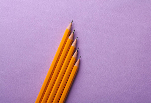 Pencils on a purple background. Creative minimal layout